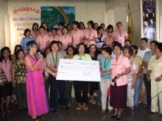 Ms. Belen Foronda received a $10,000 check from Metro Infanta Foundation to repair the social hall and gymnasium of Mt. Carmel School of Infanta. 